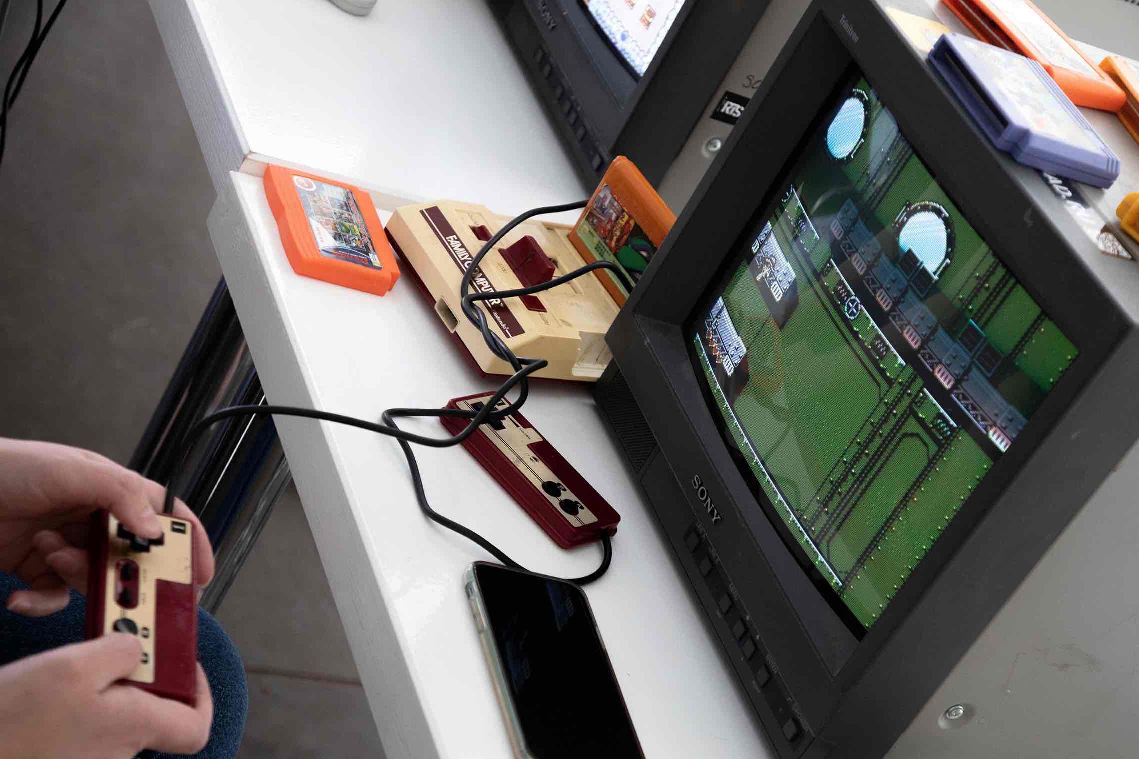 A man plays at a Nintendo Entertainment System console