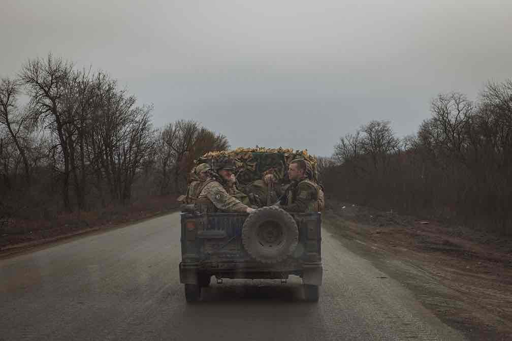Ukrainian servicemen drive in a military vehicle