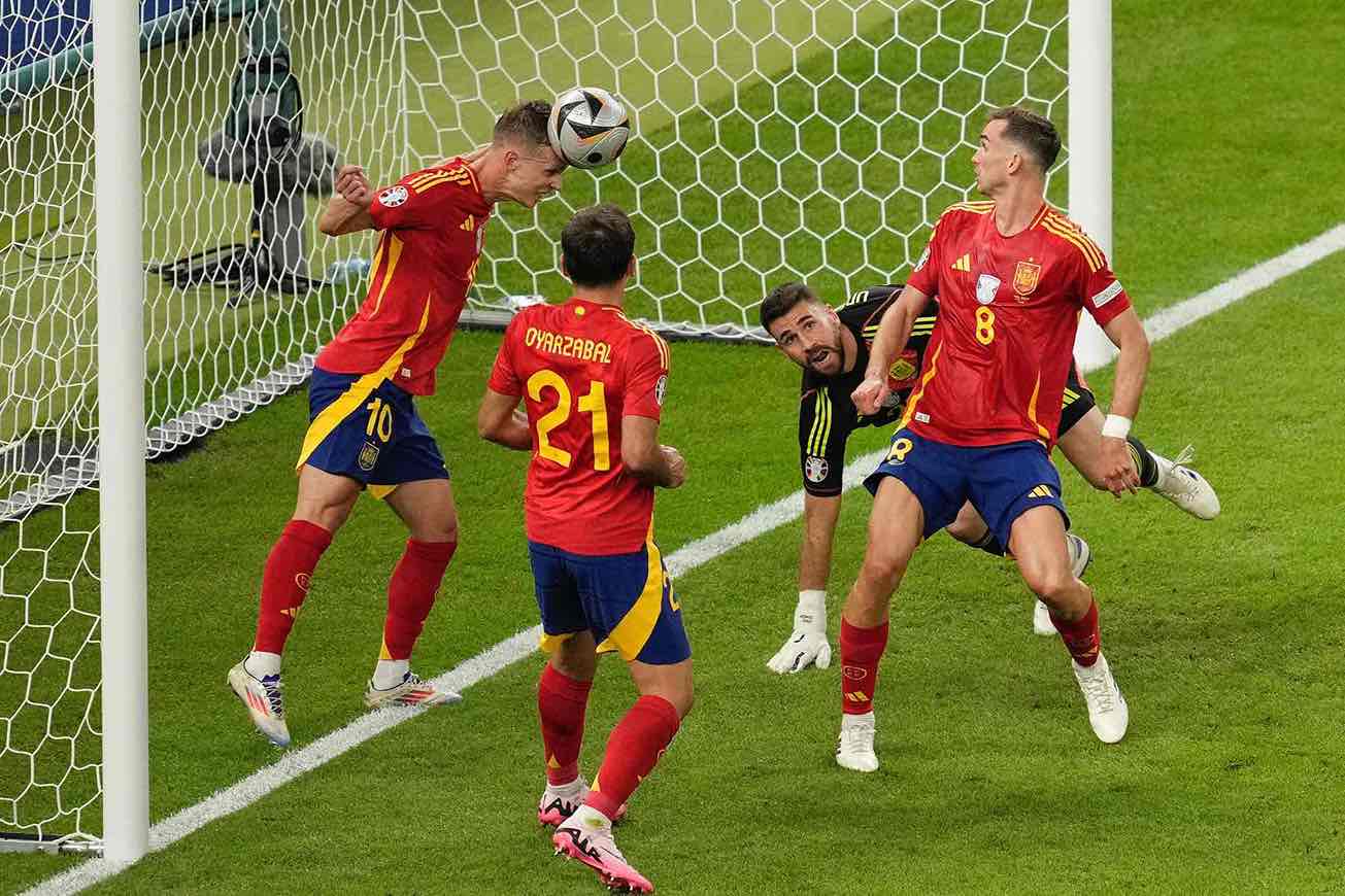 Spain's Dani Olmo clears the ball from the goal
