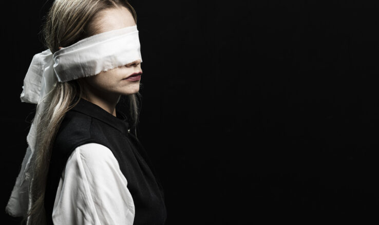 Woman with blindfold and copy space/ Femicid