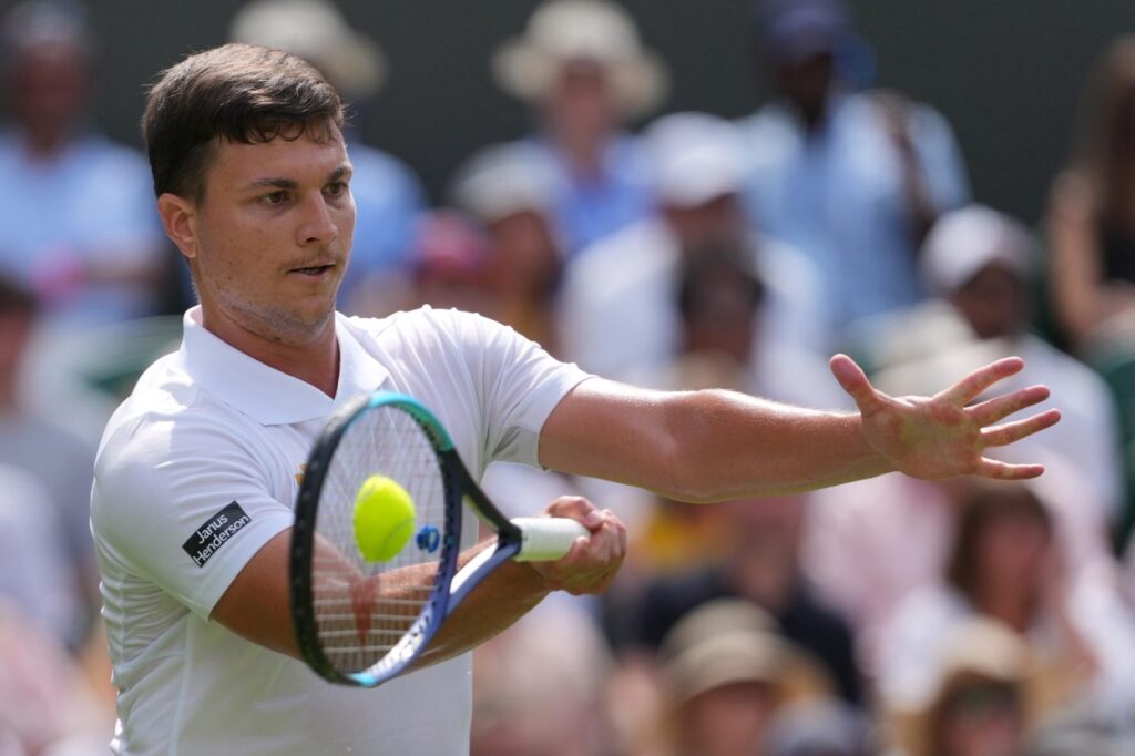 Miomir Kecmanovic of Serbia returns the ball to Jannik Sinner of Italy during the men's singles match at the Wimbledon Tennis Championships in London, Monday, June 29, 2026.(AP Photo/Kin Cheung)