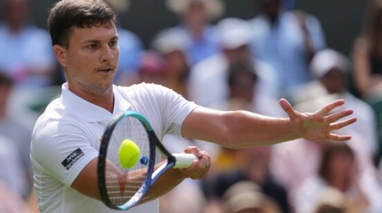 Miomir Kecmanovic of Serbia returns the ball to Jannik Sinner of Italy during the men's singles match at the Wimbledon Tennis Championships in London, Monday, June 29, 2026.(AP Photo/Kin Cheung)