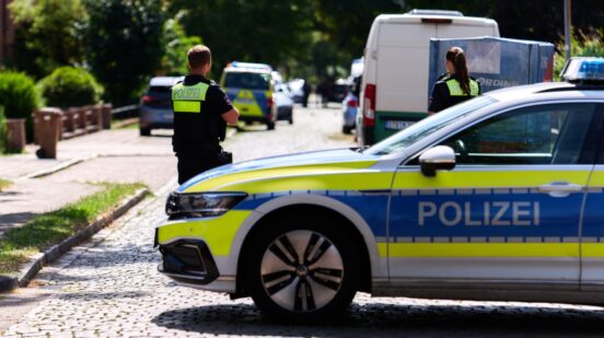 Police officers patrol the scene in Stad, Germany, Monday, June 29, 2026 following a shooting where five people were killed, police said. (Marcus Golejewski/dpa via AP)