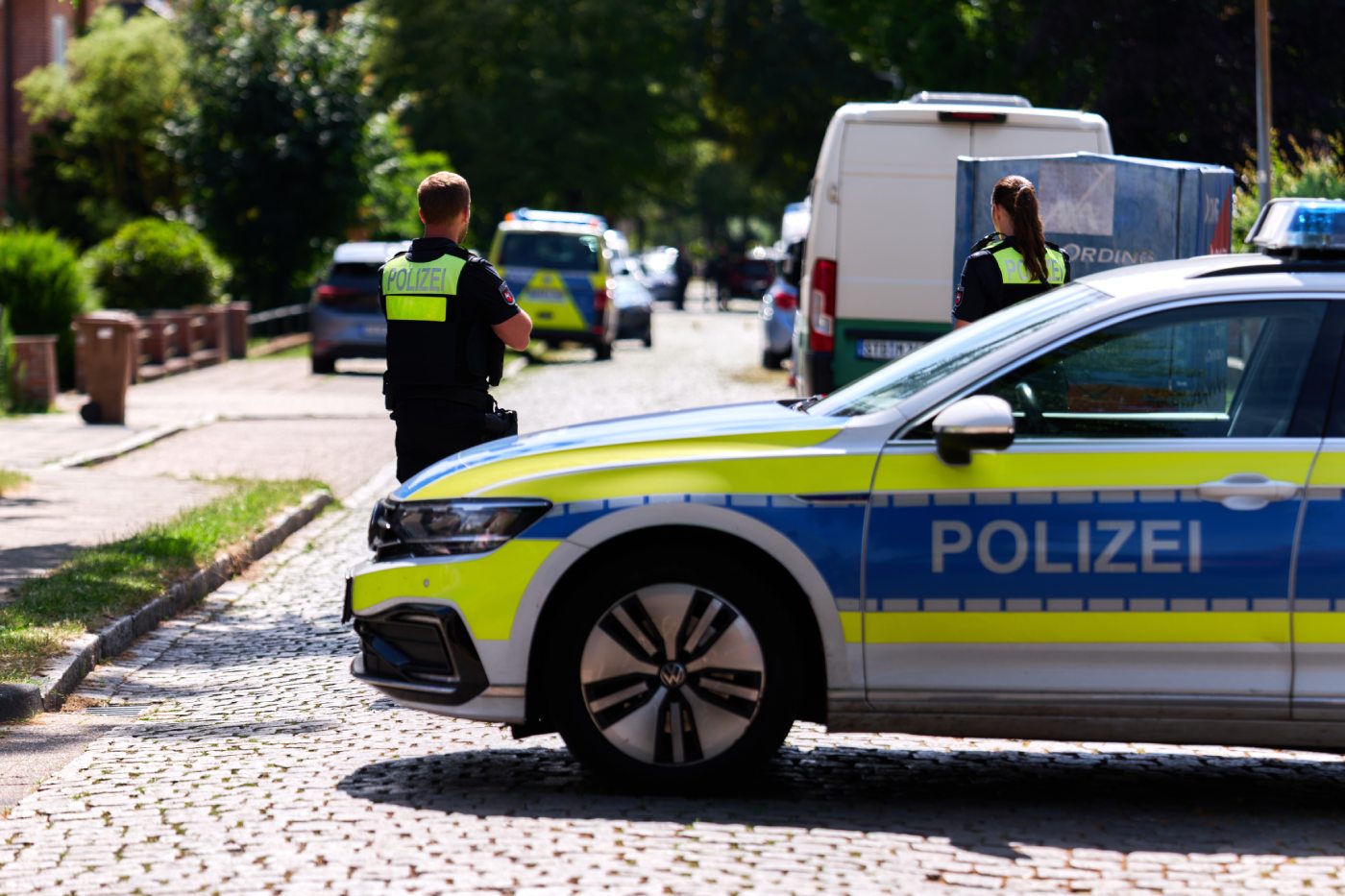 Police officers patrol the scene in Stad, Germany, Monday, June 29, 2026 following a shooting where five people were killed, police said. (Marcus Golejewski/dpa via AP)
