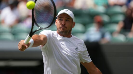 Dusan Lajovic of Serbia returns the ball to Taylor Fritz of the United States in their first round men's singles match at the Wimbledon Tennis Championships in London, Tuesday, June 30, 2026. (AP Photo/Kirsty Wigglesworth)