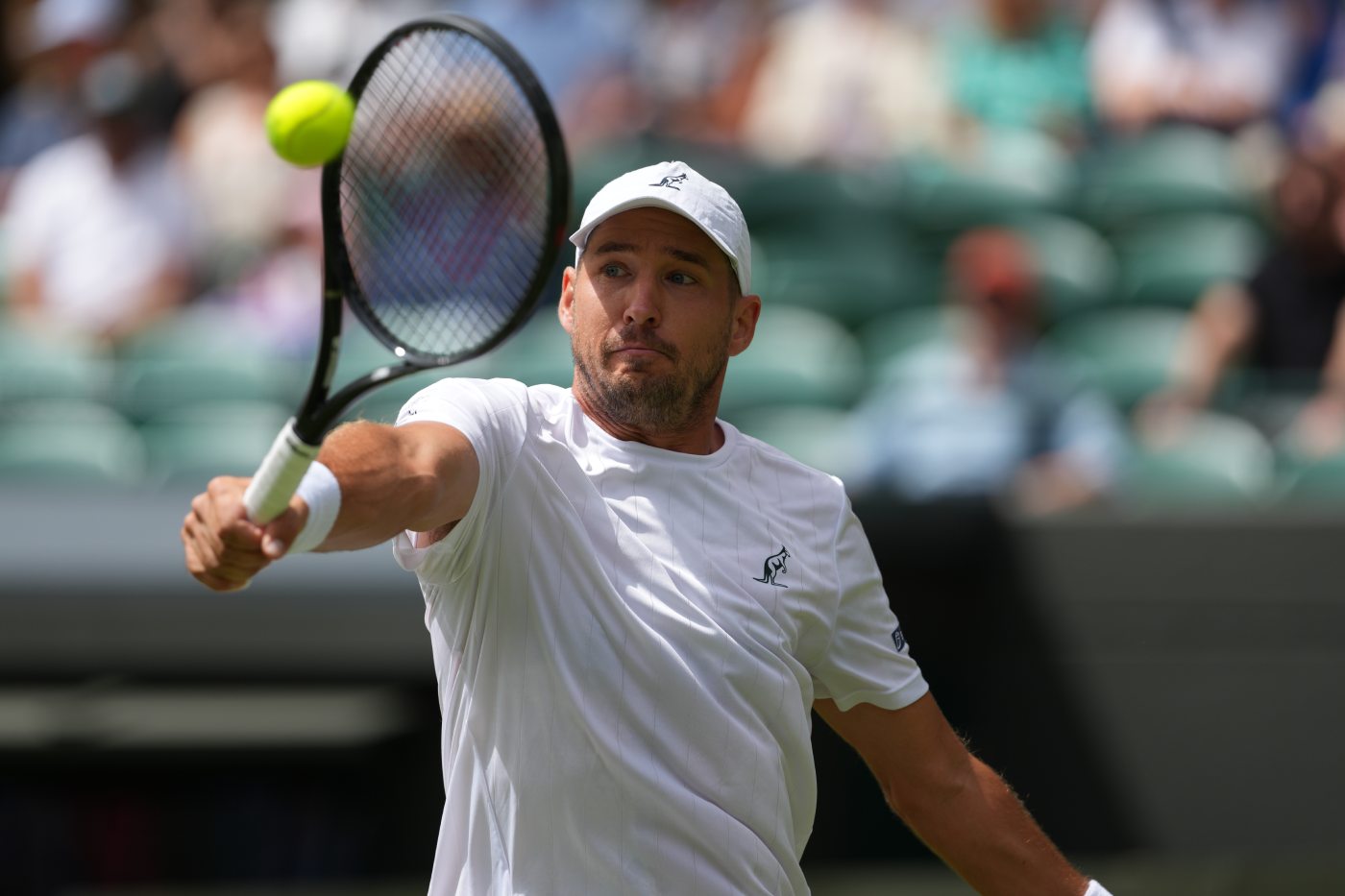 Dusan Lajovic of Serbia returns the ball to Taylor Fritz of the United States in their first round men's singles match at the Wimbledon Tennis Championships in London, Tuesday, June 30, 2026. (AP Photo/Kirsty Wigglesworth)