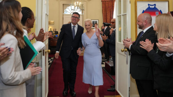 Staff clap as new Prime Minister Andy Burnham and wife Marie-France van Heel walk into 10 Downing Street in London, Monday, July 20, 2026. (AP Photo/Kin Cheung, Pool)