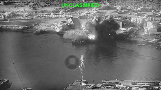 This image from video released by U.S. Central Command, shows an explosion at Bandar Abbas Naval Base, Iran, as three Corsair unmanned surface vessels, also called one-way attack surface drones, fired by the U.S. military, hit the port July 12, 2026. (U.S. Central Command via AP)