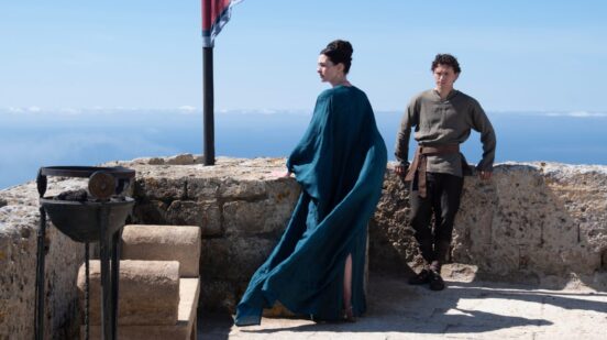 L to R: Anne Hathaway is Penelope and Tom Holland is Telemachus in THE ODYSSEY, written, produced, and directed by Christopher Nolan.