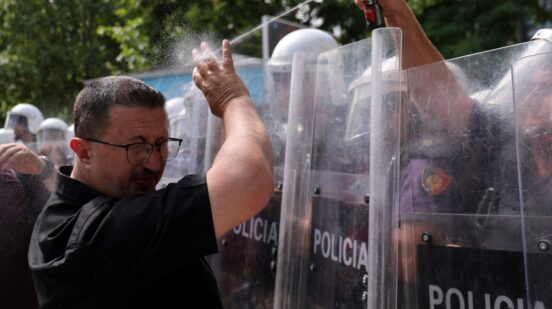 A riot police officer uses pepper spray against a protester during clashes at an anti-government rally in Tirana, Albania, Thursday, July 2, 2026. (AP Photo/Hameraldi Agolli)